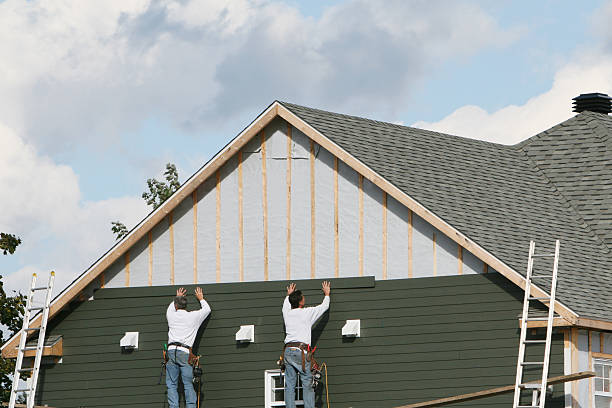 Professional Storm Damage Siding Repair technician working in Westwood, MA